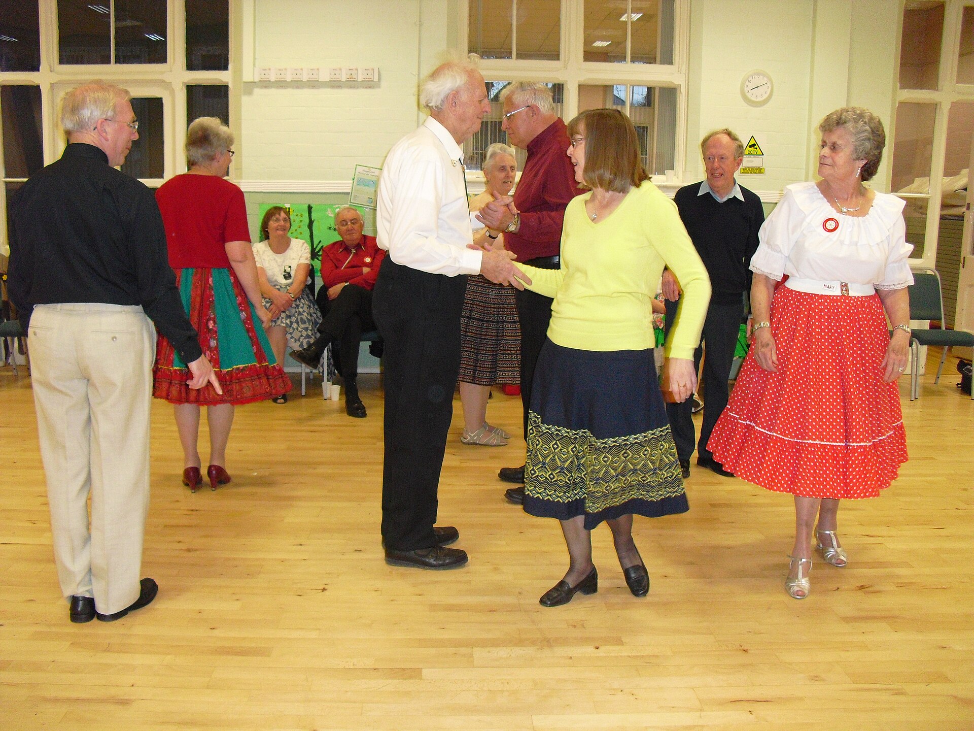 Square dancers enjoying a friendship dance in a community hall