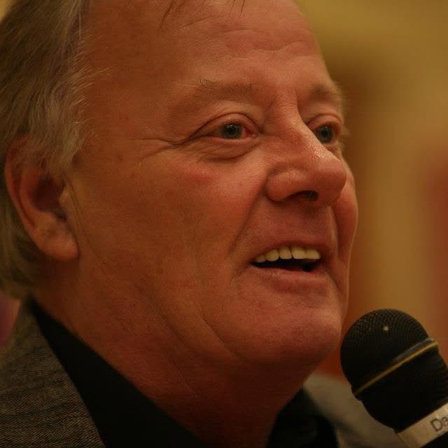 Darrell Sprague holding a microphone