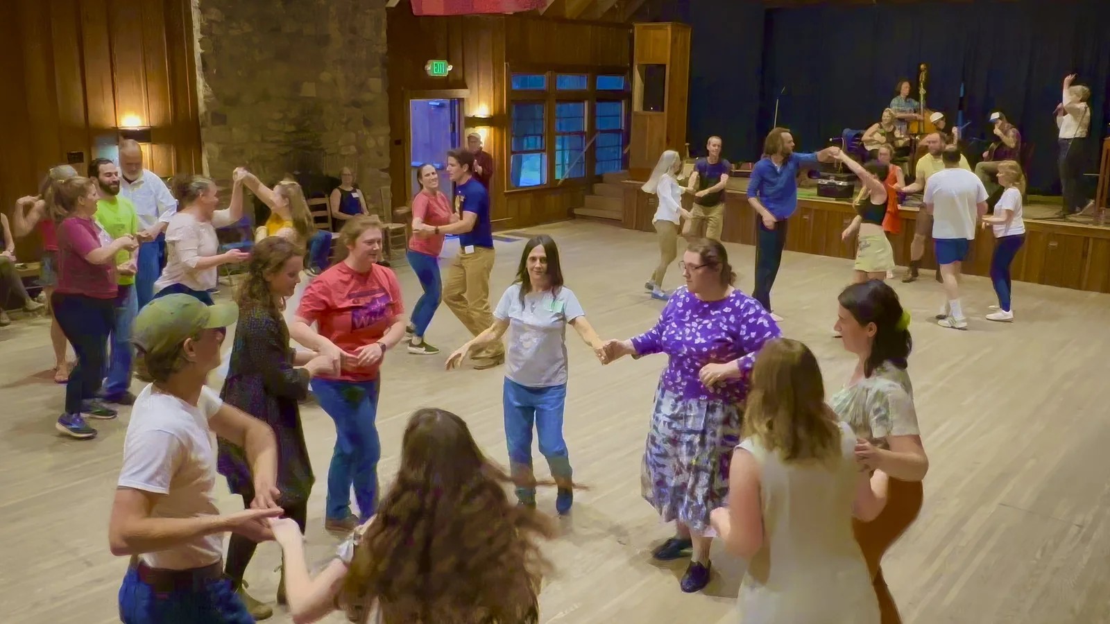 Square dancers holding hands in a group formation